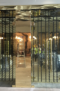 glass door wine cellar with wood framing