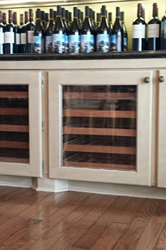 glass door wine cellar with wood framing
