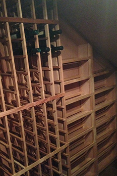small wine room under a staircase
